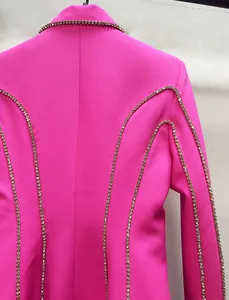 Detailed view showing sparkling crystal rhinestone trim on a hot pink designer blazer dress