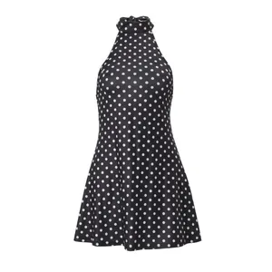 Detailed view of black and white polka dot pattern on a stylish halter neck summer dress