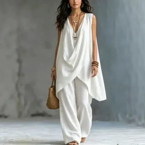Close-up of the draped neckline and textured fabric of the white cotton linen resort set