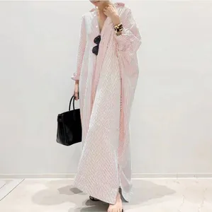 Close-up detail of a stylish oversized red and white striped maxi shirt dress for women