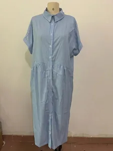 Detail of blue and white striped cotton linen shirt dress with button closure