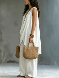 Detail of the white sleeveless cotton linen vacation set with relaxed wide-leg pants.