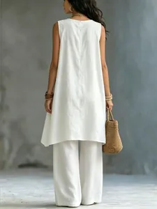 Back view of an elegant white sleeveless cotton linen resort style two-piece set