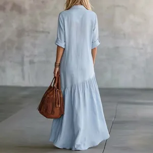 Back view of a light blue long-sleeved shirt maxi dress featuring a tiered ruffled hem