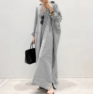 Full length detail of oversized black and white striped kaftan dress with loose fit