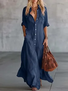 Full-length navy blue button-down shirt maxi dress with pockets and fringe bag