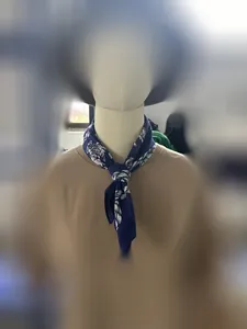 Detailed view of navy blue cotton hip-hop bandana with white patterns on mannequin
