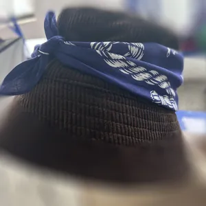 Close-up detail of a blue paisley cotton bandana tied around a brown corduroy hat