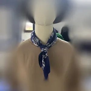 Vintage blue cotton square bandana with white paisley prints tied on a mannequin neck