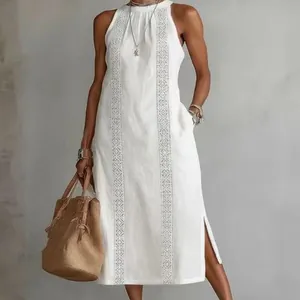 Full view of a white sleeveless maxi dress with ethnic embroidery and side slits