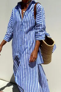 Close-up detail of a blue and white striped shirt dress with half sleeves and side slit