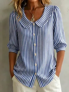 Close-up detail of a blue and white striped shirt featuring a Peter Pan collar and puff sleeves