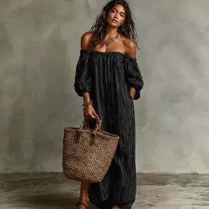 Elegant off-shoulder black striped summer maxi dress with boho straw basket bag