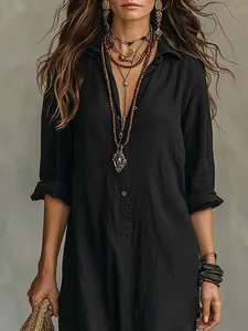 Close-up detail of a casual black long dress with bohemian-style layered accessories