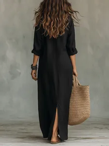 Back view of a casual black linen maxi dress featuring a high back slit and relaxed fit