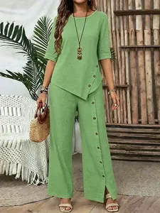 Elegant green two-piece set featuring asymmetrical hem and decorative side buttons