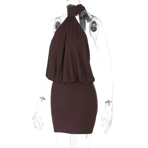 Close-up showing the halter neck and bodycon fit of this brown backless mini dress.