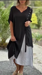 Full view of black and gray asymmetrical fake two-piece V-neck dress outdoors