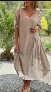 Beige V-neck short sleeve dress with layered asymmetrical hem and button details.