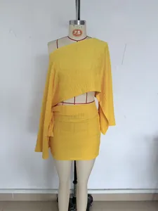 Vue détaillée de l'ensemble jaune avec haut à une épaule et jupe texturée sur mannequin