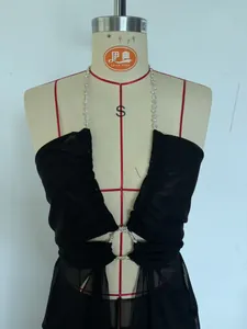 Close-up of black sheer mesh halter dress with sparkling rhinestone straps and V-neck.