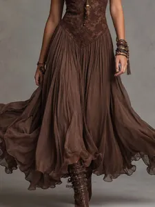 Macro view of vintage brown lace patchwork and delicate pleated flowy maxi dress