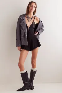 Chic European style black denim romper for women featuring a deep V-neck and loose fit design