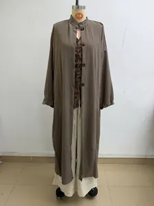 Vue détaillée d'un ensemble de 3 pièces incluant long gilet taupe et haut imprimé.