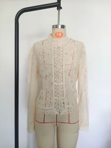 Elegant beige floral lace blouse featuring a high collar and traditional frog buttons