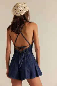 Detailed back view of a stylish dark blue denim romper showing crisscross tie details