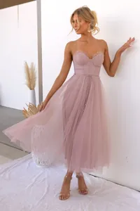 Detail of mauve mesh evening dress with spaghetti straps and flowing tulle skirt