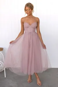 Elegant dusty rose tulle evening dress featuring spaghetti straps and ruffled bodice details