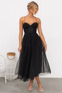 Elegant black corset dress with spaghetti straps and voluminous tulle midi skirt