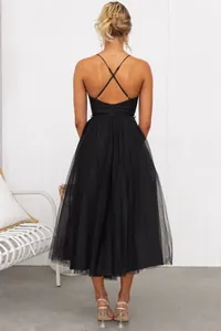 Back view of a black spaghetti strap evening dress with a layered tulle skirt.