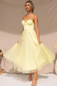 Elegant pale yellow mesh evening dress featuring a sexy suspender design and corset bodice.