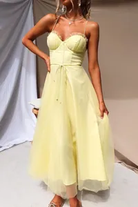 Detailed view of a sexy yellow camisole tulle mesh evening dress with corset bodice