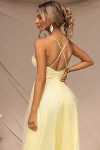 Detailed back view of a sexy pale yellow mesh evening dress featuring cross spaghetti straps