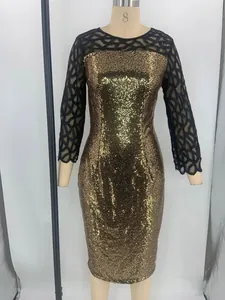 Close-up of a gold sequin party dress with black mesh sleeves on a mannequin.