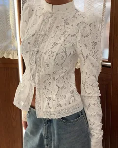 Detailed view of white floral lace blouse featuring mandarin collar and knot buttons