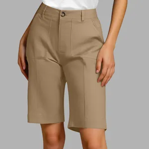 Close-up of khaki high-waisted tailored Bermuda shorts on female model for summer