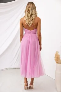 Back view of pink tulle evening dress with elegant spaghetti straps and mesh skirt.