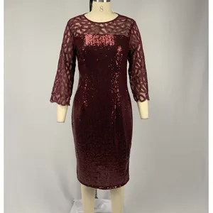 Detail of burgundy sequin party dress with mesh lace sleeves on mannequin