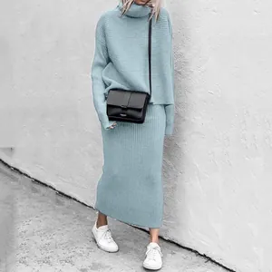 Close-up of light blue knitted turtleneck sweater and maxi skirt set worn by a model