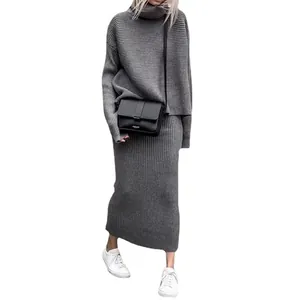 Elegant gray two-piece knit set featuring an oversized turtleneck sweater and midi skirt