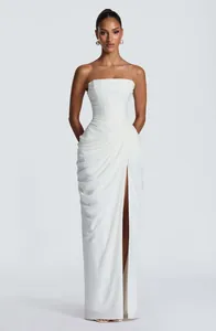Elegant white strapless maxi dress with asymmetric draping and sexy high side slit.