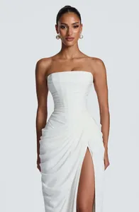 Elegant white strapless dress featuring asymmetric draping and a high leg slit detail.