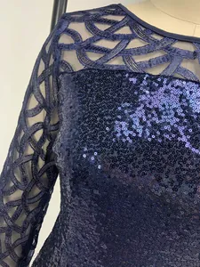 Close-up detail of navy blue sequin dress with intricate geometric mesh embroidery