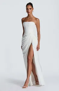 Elegant white strapless maxi dress with asymmetric pleats and high slit for women.