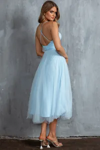 Detailed back view of a light blue spaghetti strap tulle midi evening dress with cross straps