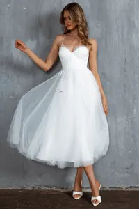 Detailed view of white tulle midi dress with corset bodice and ruffle trim